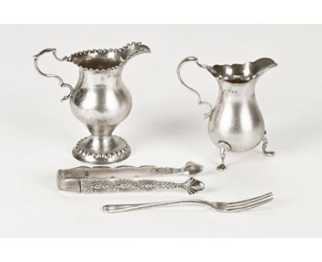 Two silver cream jugs, the tallest probably London 1775 but hallmark and makers mark rubbed, the smaller London 1927 maker pr