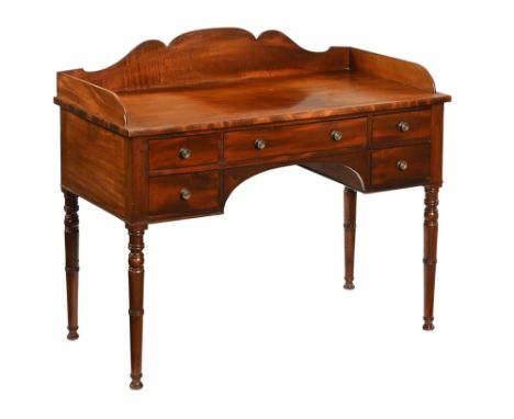 A Regency mahogany washstand, with shaped backboard on an upper rectangular top over one long frieze drawer and two smaller s