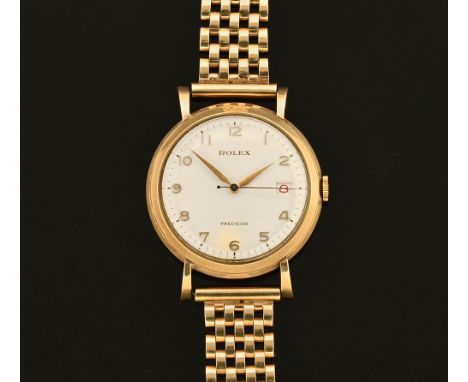 A vintage Rolex manual wind wristwatch with date aperture, 9 ct gold case, the 35 mm case housing a honeycomb dial with Arabi