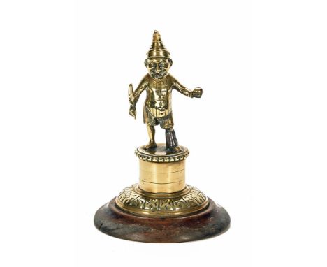 A Victorian brass mahogany mounted Mr Punch Tobacconist Counter gas lighter.  Height 22 cm, base diameter 15 cm (see illustra