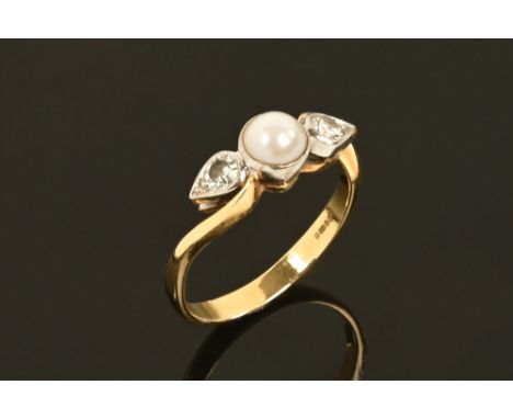 An 18 ct yellow gold Scottish river pearl and diamond ring, the centre pearl flanked on either side by a millegrain set diamo