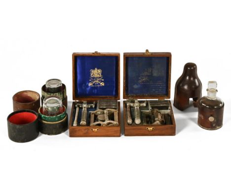 Two vintage oak cased Wilkinson Sword razors, together with a poison bottle and two measures.