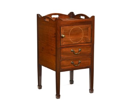A George III mahogany tray top commode, converted to a cupboard and chest with brass handles and raised on tapered legs termi