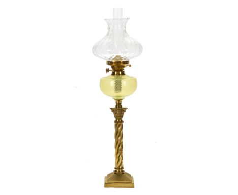 A Victorian brass oil lamp, with vaseline glass reservoir and clear shade.  Height including chimney 81 cm. CONDITION REPORT: