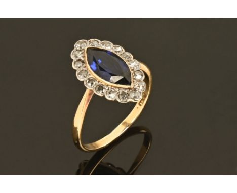 An 18 ct yellow gold sapphire and diamond cluster ring, millegrain set, dimensions of sapphire +/- 12 mm x 6 mm (see illustra