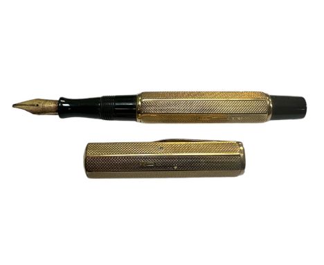 A Waterman Ideal lever fill fountain pen with a 9ct engine turned gold cap and barrel cover having Waterman 14ct nib, approx.