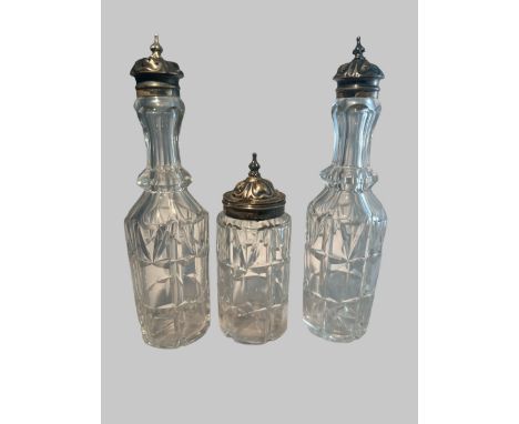 Three Victorian cut glass bottles with silver mounts, probably part of a cruet set. Birmingham hallmarks for 1869.