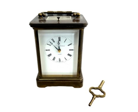 A brass cased carriage clock with bevelled glass panels, Matthew Norman of London, complete with key.
