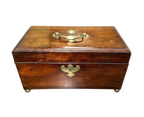 A mahogany hinged-lid tea caddy on four brass round ball feet. Three compartments, brass handle on lid, without key. Height 1