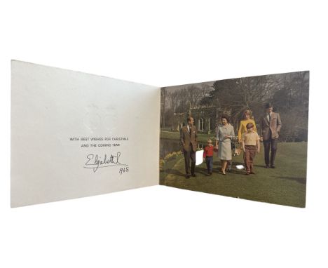 A 1968 Christmas Card sent from Queen Elizabeth II. Twin Royal ciphers to cover, photograph of the Royal Family walking in a 