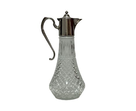 A glass claret jug with silver plated mount decorated with a beaded edge, approx 30cm high. Very good condition