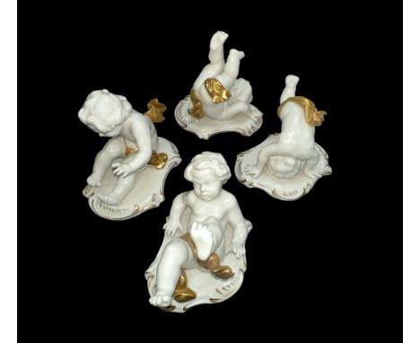 Rudolph Krammer set of four ceramic cherubs with gold gilt details. Each with the Rudolph Krammer ‘K’ under a crown stamp to 