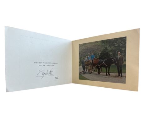 A 1966 Christmas card from HM Queen Elizabeth II. Two gilt cyphers to cover, interior with photograph of the Royal Family in 