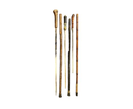 Three sword / dagger sticks, one bamboo with 42cm blade and total length 92cm, dark wood with brass collar and top has 57cm b