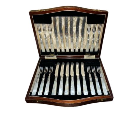 A twenty-four piece Victorian hallmarked silver dessert cutlery set with silver forks and blade on mother of pearl handles in