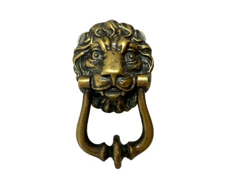 A brass lion head door knocker with twin bolt fixing. Height 12.5cm, Width 7cm, Depth 3.5cm.