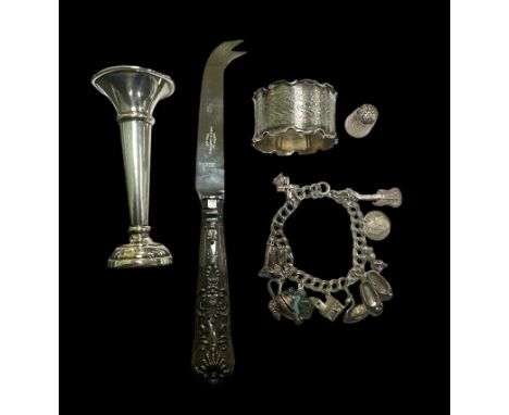 A range of silver items including a napkin holder, thimble, candlestick (weighted) and a boxed cheese knife with a silver han