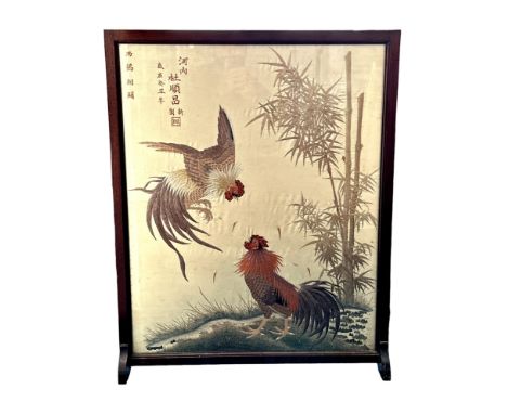 A Japanese silk fire screen in mahogany frame, featuring two chickens next to a river.