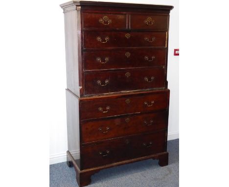 A late 18th century mahogany chest on chest; the outset cornice above two half-width and six full-width graduated drawers, th