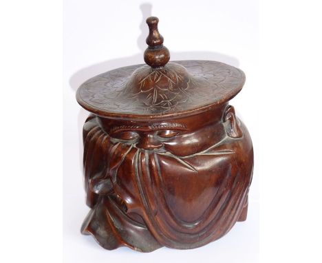 A late 19th/early 20th century Chinese hardwood tobacco jar carved in the shape of a cloaked gentleman with wide-brimmed hat,