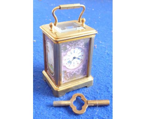 A novelty miniature gilt-metal and porcelain-mounted carriage clock; white-enamel dial with Roman numerals surrounded by foli