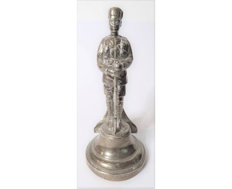 A silver menu holder in the form of an askari of the King’s African Rifles by the Goldsmiths & Silversmiths Co, London 1925 