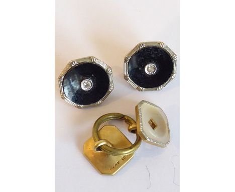 A pair of black-enamel buttons, the reverse is marked GAF 9CT &amp; 18CT, each set with a small white stone testing positive 