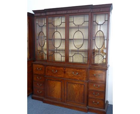 A very fine late 18th century breakfront mahogany library secretaire bookcase; the dentil cornice above fluted frieze headed 