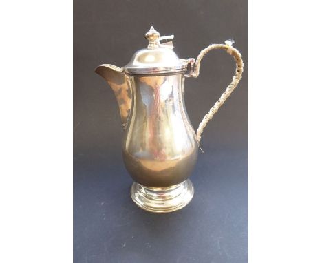 A heavy hallmarked silver baluster-shaped hot-water jug with hinged lid, maker's mark 'S &amp; Co', assayed London 1913 (20cm