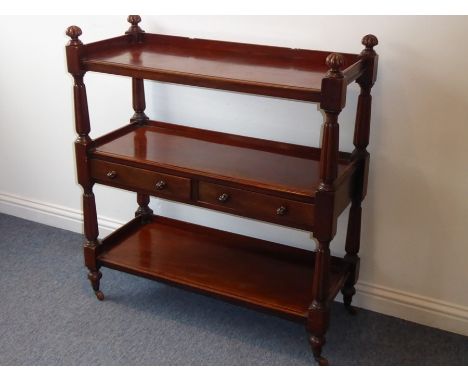 A late Regency/early William IV mahogany buffet; the three-quarter galleried top with large gadrooned mushroom-style finials 