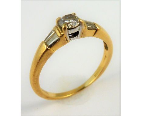 An 18-carat gold solitaire diamond ring set with baguette diamond shoulders; ring size M&nbsp;(total weight approx. 2.97g) (T
