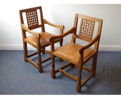 A good pair of Robert 'Mouseman' Thompson of Kilburn open armchairs; latticework backs above original tan leather, and each r