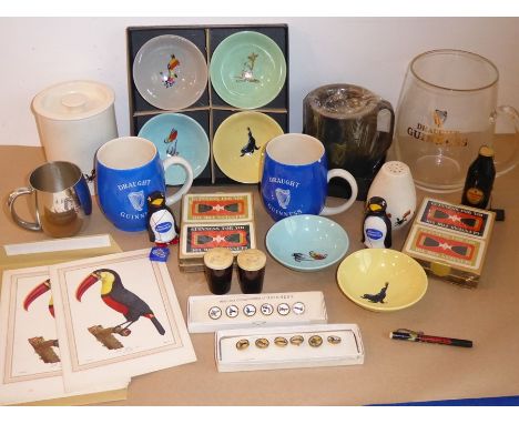 A good and interesting collection of Guinness Brewery memorabilia; to include tankards, an oversized glass tankard, metal tan