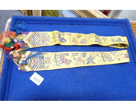 A finely worked Chinese silk needlework with two rectangular panels decorated with Shou characters and floral sprigs, two fur