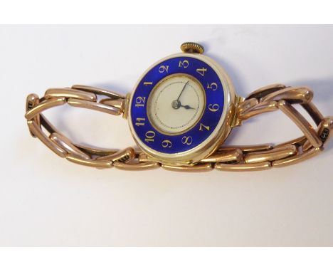 A lady's early 20th century 15-carat yellow-gold cased wristwatch; the outer case with blue-enamel dial and Arabic numerals, 