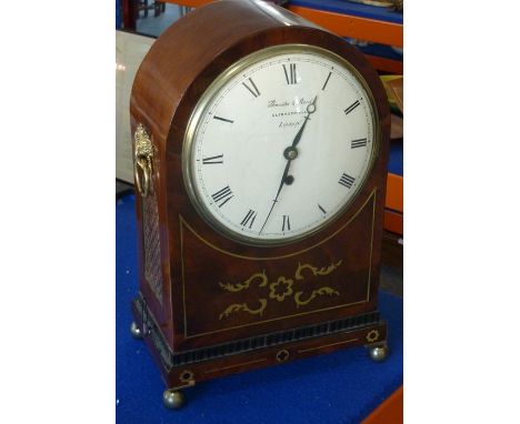 An early 19th century eight-day mahogany and brass-inlaid bracket clock; cream dial with Roman numerals and signed Thwaites &