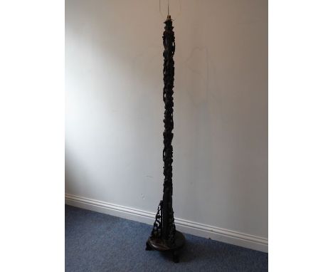 An early 20th century Chinese hardwood lamp standard carved in high relief with prunus blossom etc. on circular base and thre