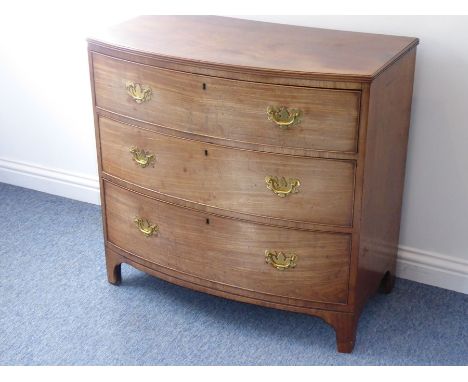 An early 19th bow-fronted mahogany chest (faded); the reeded edge top above three full-width graduated drawers, raised on hig