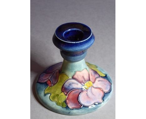 An early 20th century William Moorcroft Pottery squat candlestick in the Hibiscus pattern; Moorcroft stamped to one side and 