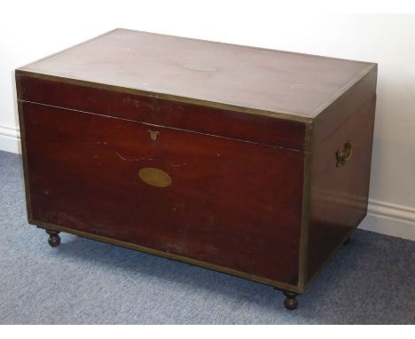 A brass-bound two-handled Anglo-Indian hardwood trunk; vacant oval inset brass cartouches to the hinged top section and front