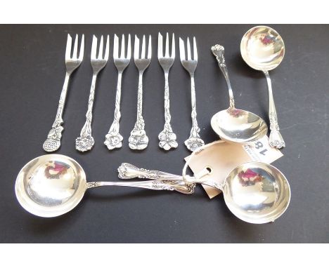 Four small spoons with circular bowls (marked sterling), together with six white-metal dessert forks, each finial modelled as