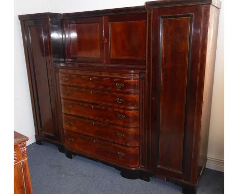 A Regency period gentleman's mahogany and boxwood-strung compactum; the inverted breakfront cornice above two panelled doors 