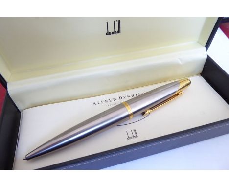 A modern cased Alfred Dunhill AD 2000 biro pen; brushed-steel cigar-shaped barrel with gold-plated mounts (together with pape