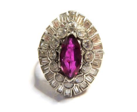 A ruby and diamond-set dress ring; the central navette-shaped ruby claw set above a surround of brilliant-cut diamonds, to th