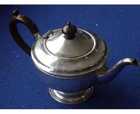 A hallmarked silver teapot; early 20th century, maker's mark TS, Birmingham assay marks (total weight including handle and fi