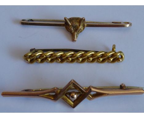 A 9-carat yellow-gold stick pin centrally mounted with a fox's head, one further similar sized 9-carat gold stick pin decorat