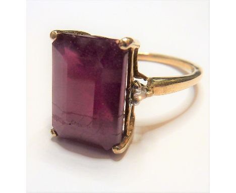 A ladies gold ring set with a large ruby and two small diamonds&nbsp;(The cost of&nbsp;UK postage&nbsp;via Royal Mail Special