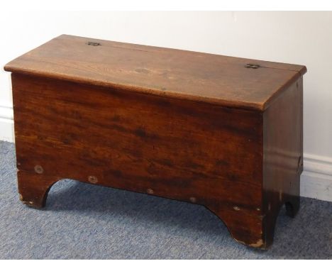 A late 18th/early 19th century elm chest of small proportions, the hinged top above shaped bracket-style feet (71cm wide x 29
