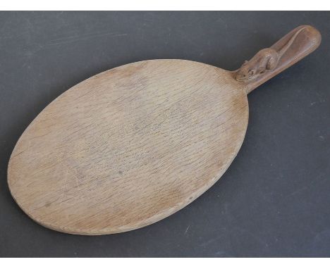 A Robert 'Mouseman' Thompson of Kilburn oval oak cheeseboard, the handle with signature mouse (37.5cm long) (probably mid-20t