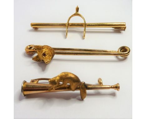 Three yellow-gold bar brooches of hunting interest: one with a fox's head with ruby eyes (fitted case); one in 15-carat gold 